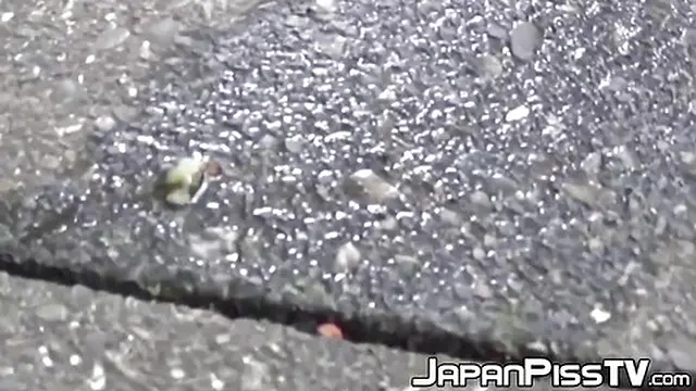 Sexy Japanese girl urinating near a parked bike