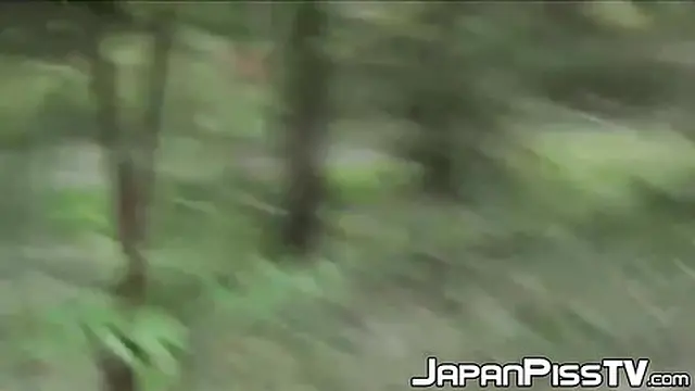 Hot Japanese girl urinates behind bench in park