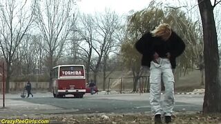 Young girl pissing on street